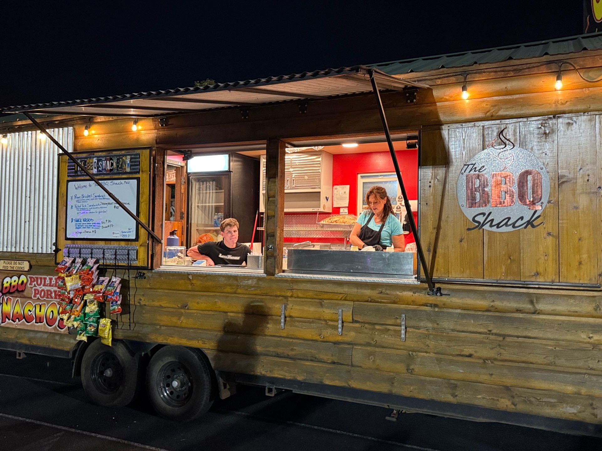 The BBQ Shack PNW food truck serving guests at an evening event